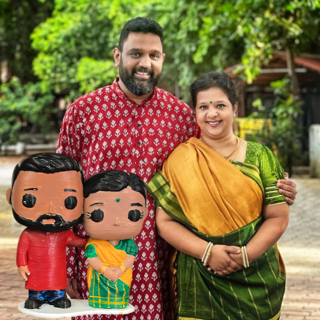 Couple holding their custom figurines beside them, showing the likeness and scale